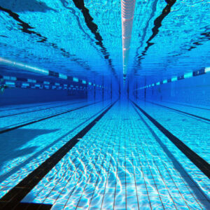 50 meter sports pool. Swimming pool underwater background.
