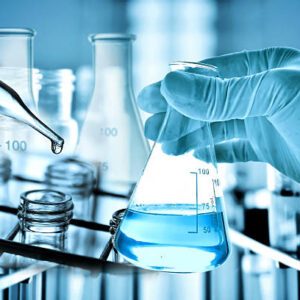 Flask in scientist hand with laboratory background, science research and development concept.